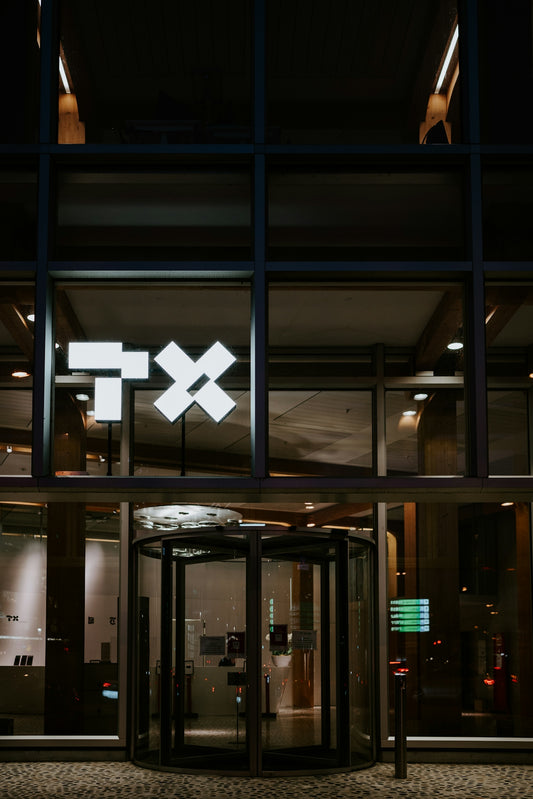 a building with a lit up exit way at night